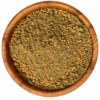 Zaatar rood in een ronde houten kom op een witte achtergrond.
